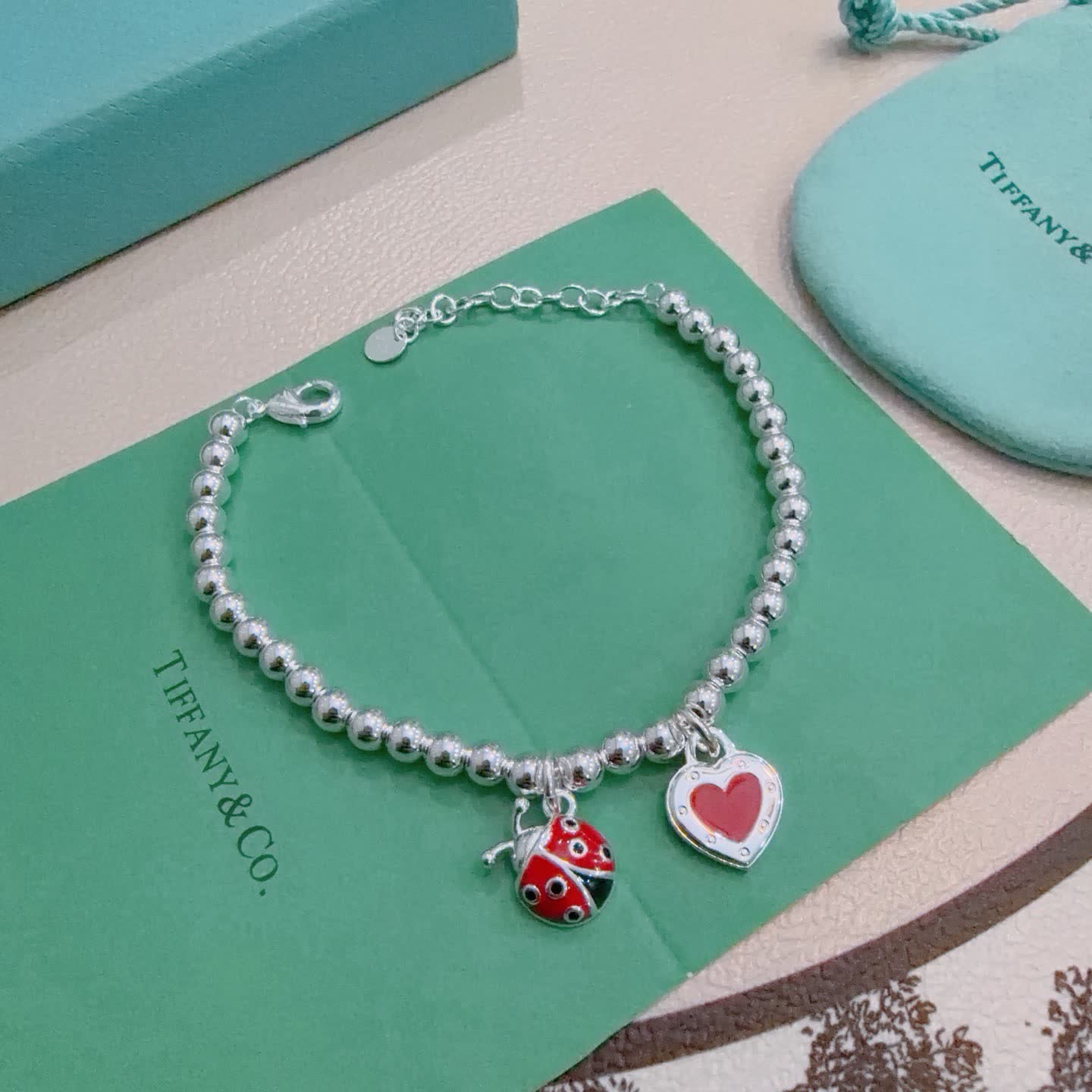 Tiffany & Co. Silver Bead Bracelet with Ladybug and Heart Charms